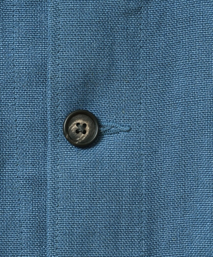 Close-up of a blue fabric texture with a button