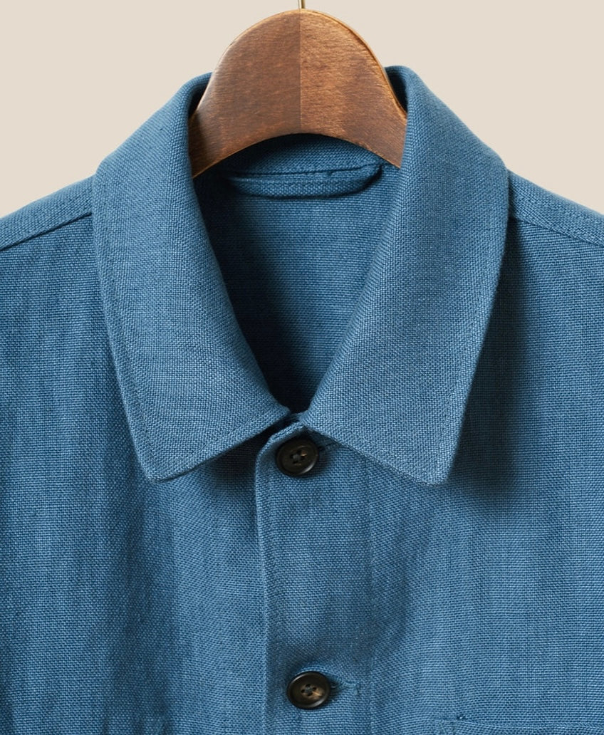 Blue shirt with collar and buttons on a beige background