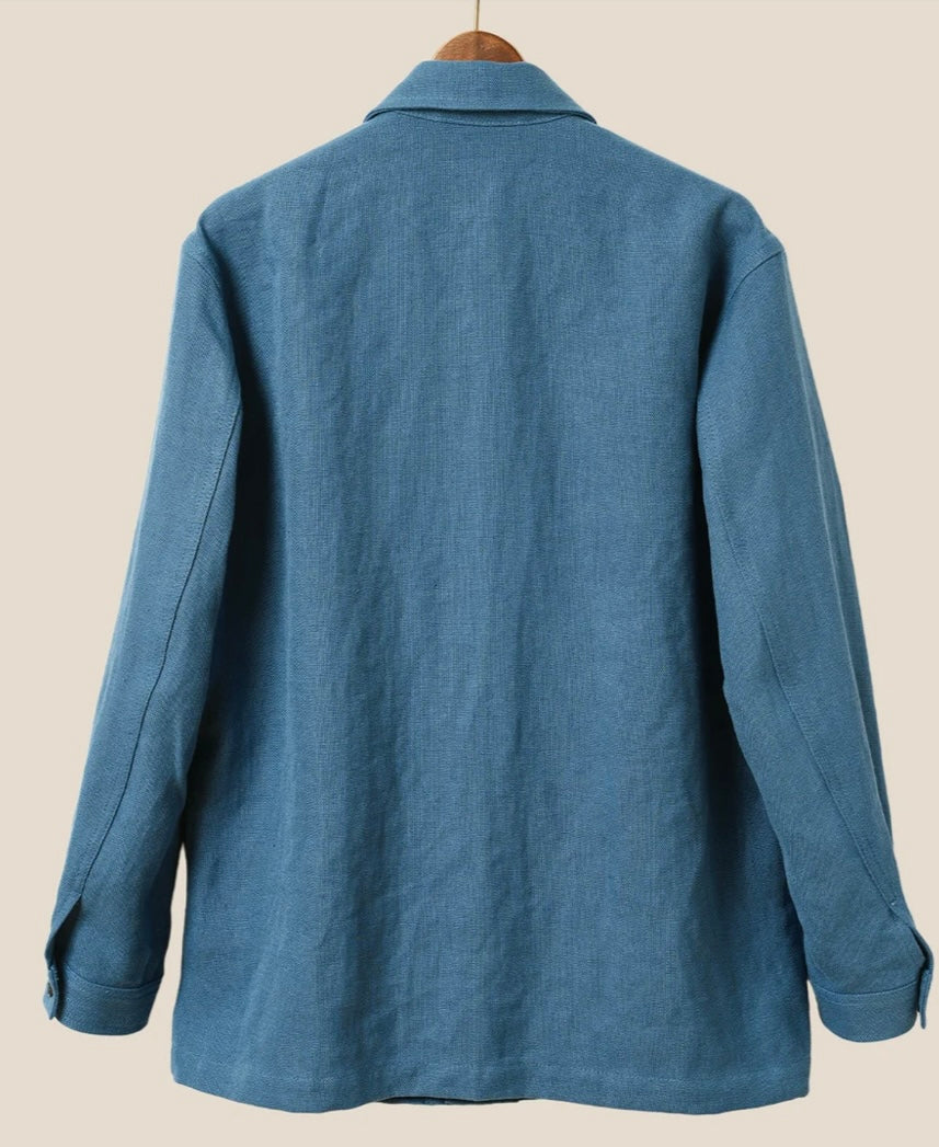 Blue shirt on a hanger against a beige background