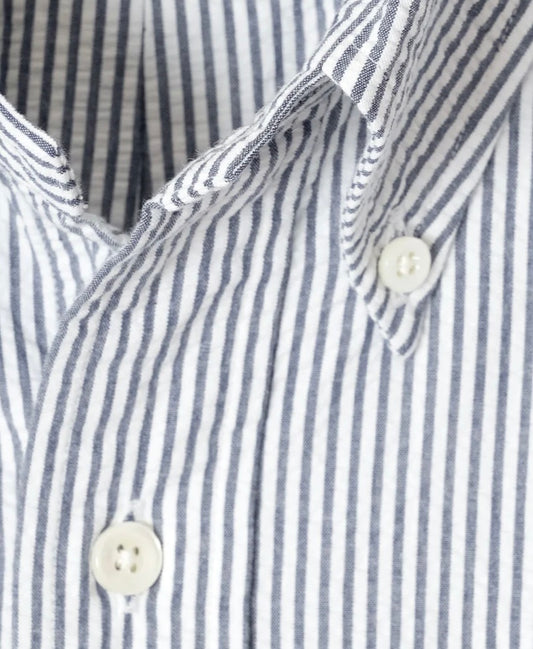 Close-up of a blue and white striped shirt with buttons.