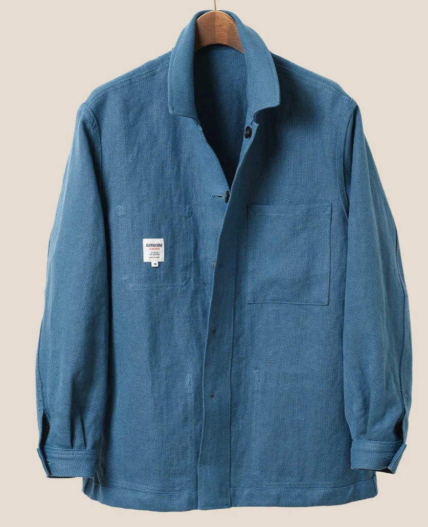 Blue jacket on a hanger against a beige background