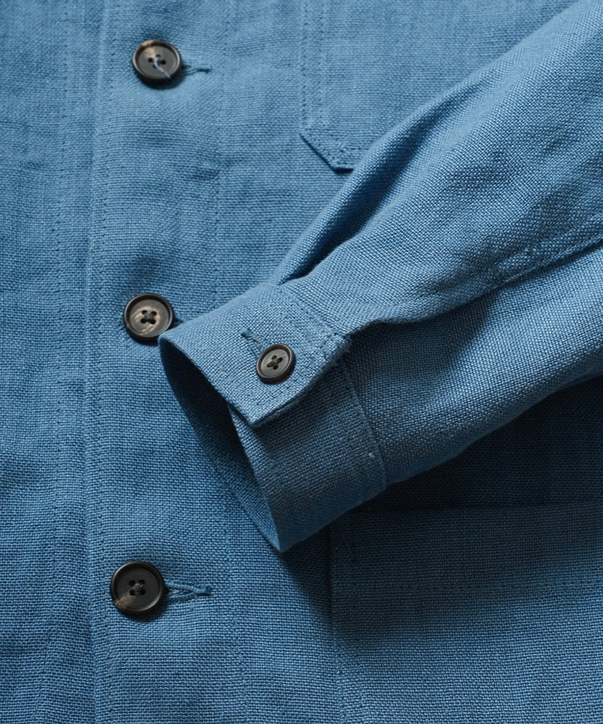 Close-up of a blue shirt with buttons and a collar