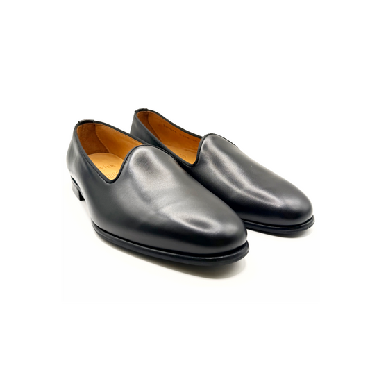Pair of black leather shoes on a white background