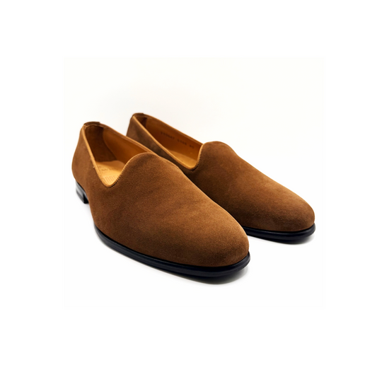 Pair of brown suede shoes on a white background