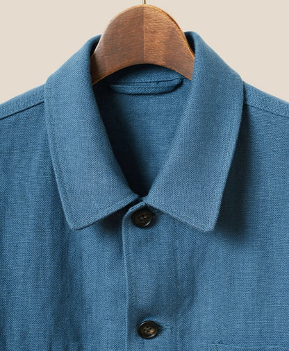 Blue shirt with collar and buttons on a beige background