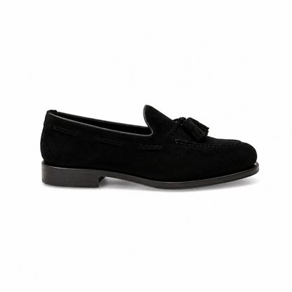 Navy blue loafer shoe on a light gray background