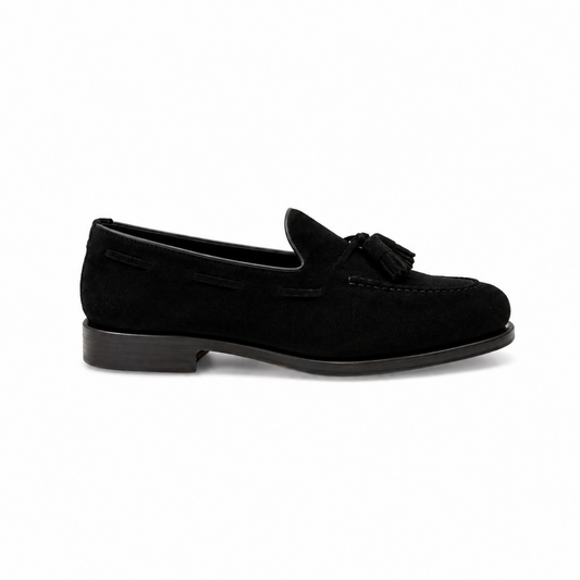 Navy blue loafer shoe on a light gray background