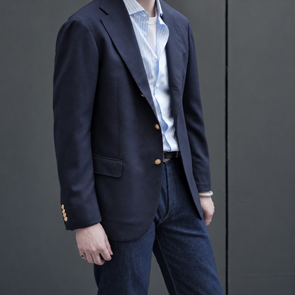 Navy Ring Jacket blazer with tailored fit and classic lapel, displayed on a hanger.