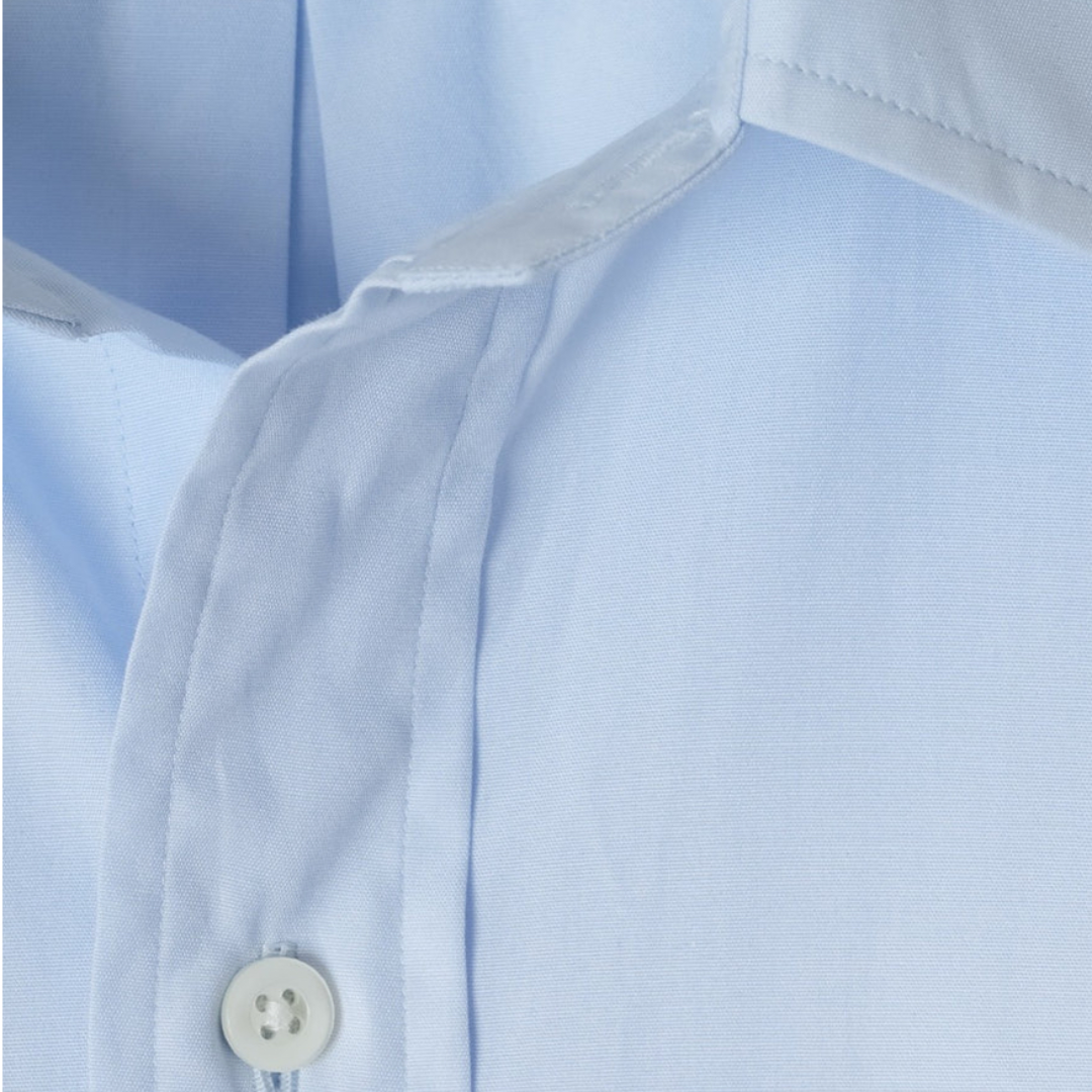Close-up of a light blue shirt with a button, showing fabric texture.