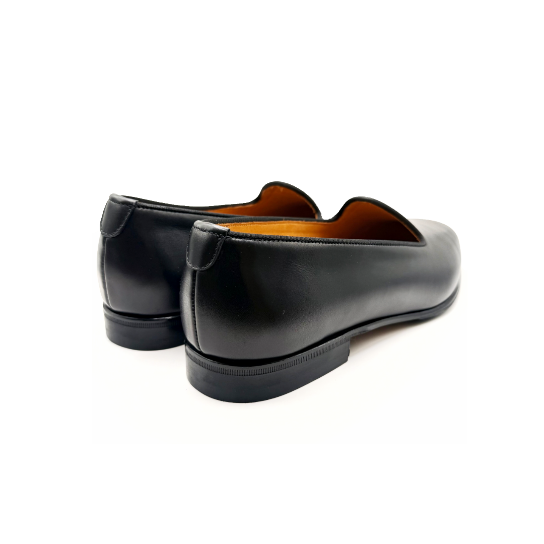 Pair of black leather shoes on a white background