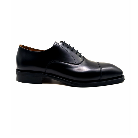 Black leather dress shoe on a white background