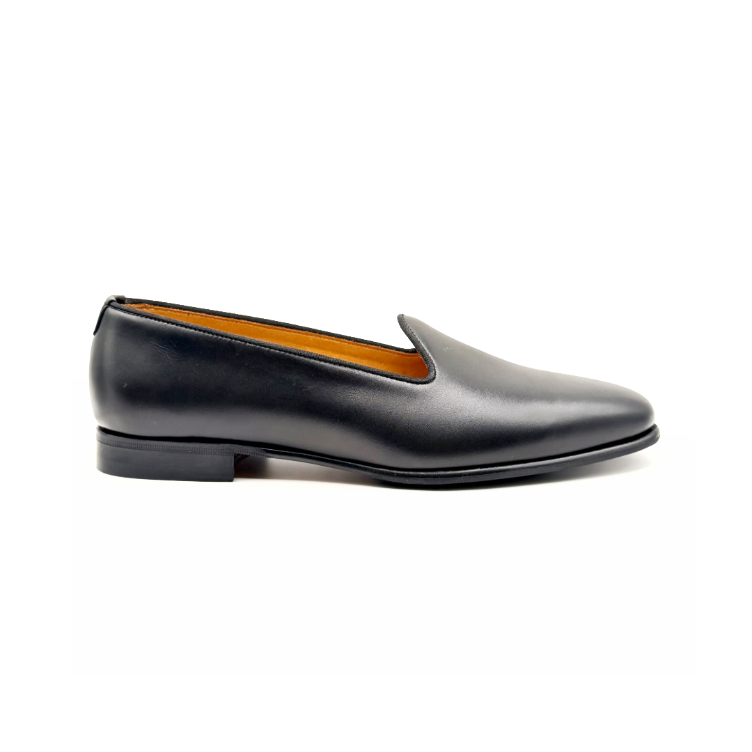 Black leather loafer shoe on a white background