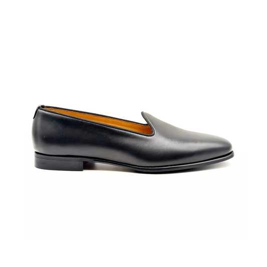 Black leather loafer shoe on a white background