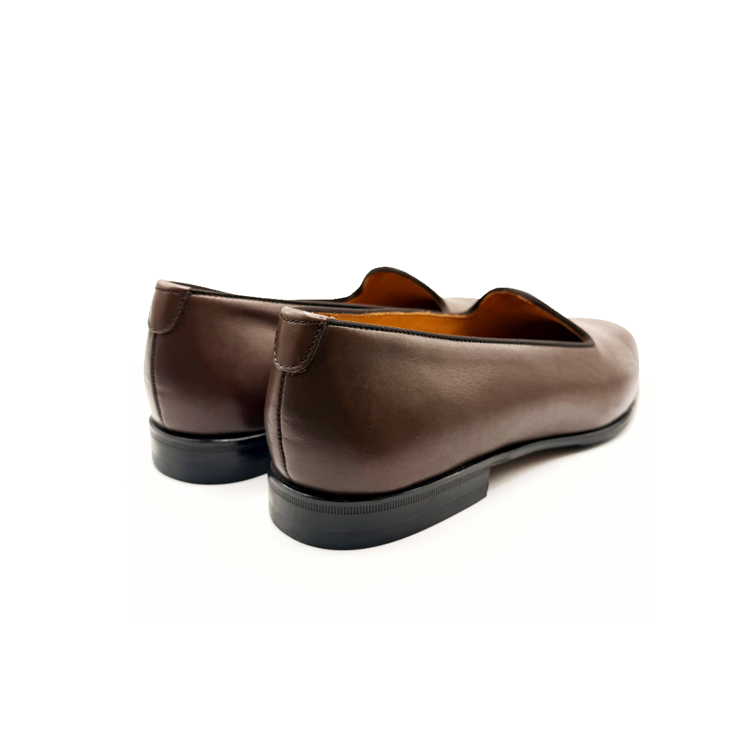 Pair of brown loafers on a white background