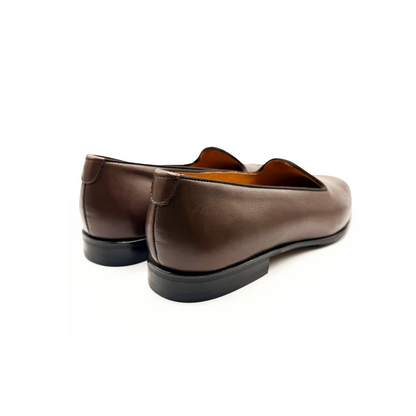 Pair of brown loafers on a white background