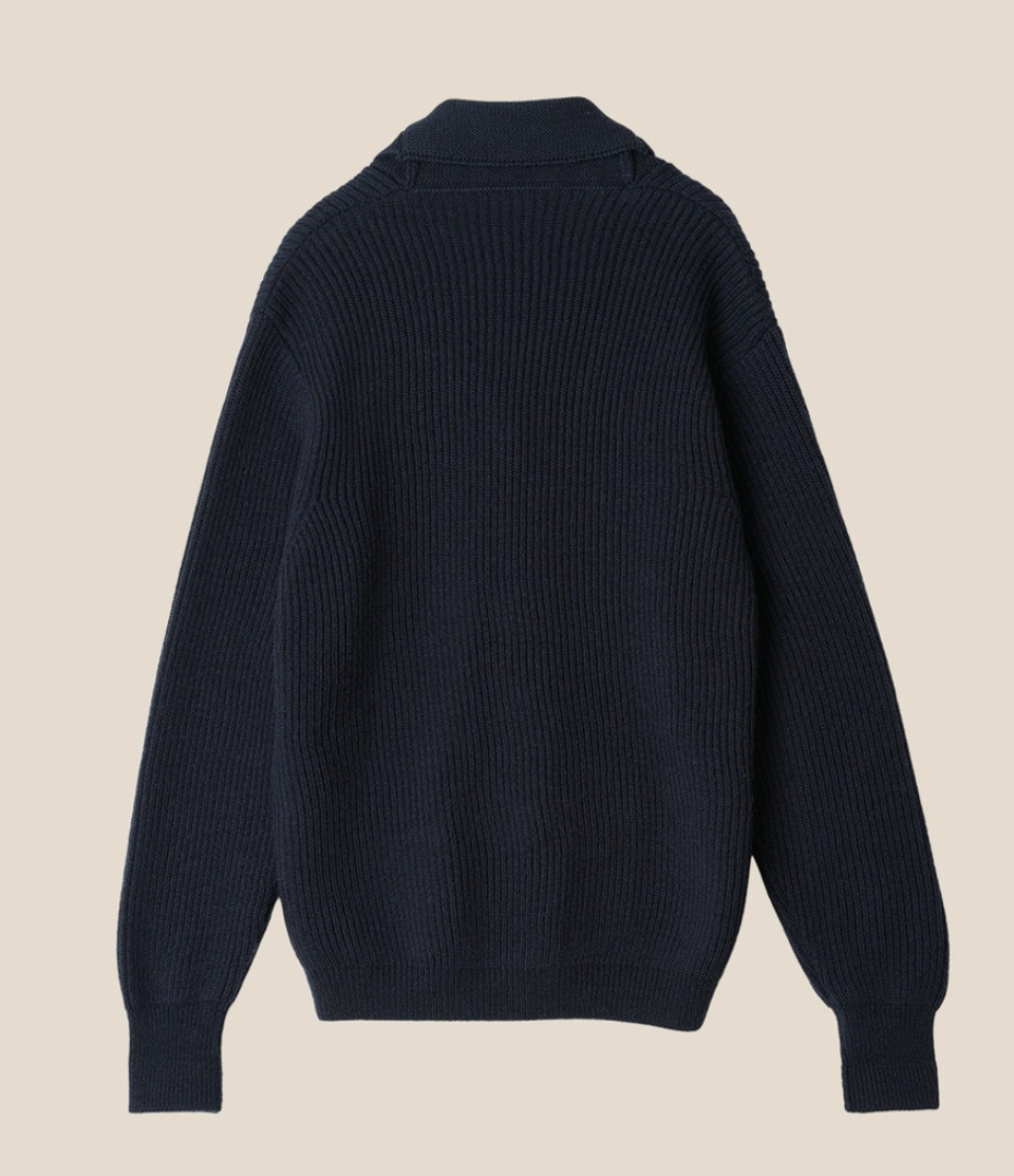 Navy blue sweater on a beige background