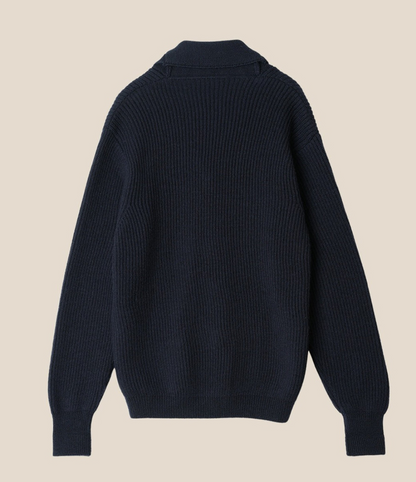 Navy blue sweater on a beige background