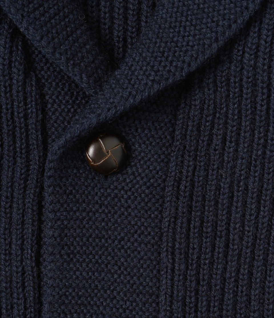 Close-up of a dark blue textured fabric with a button