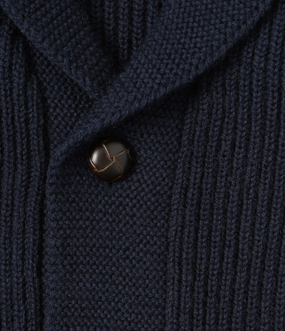 Close-up of a dark blue textured fabric with a button