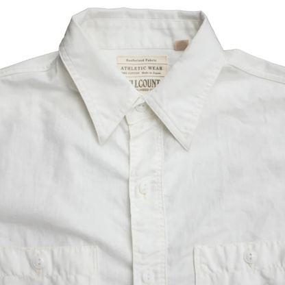 White shirt with a visible brand label on a white background