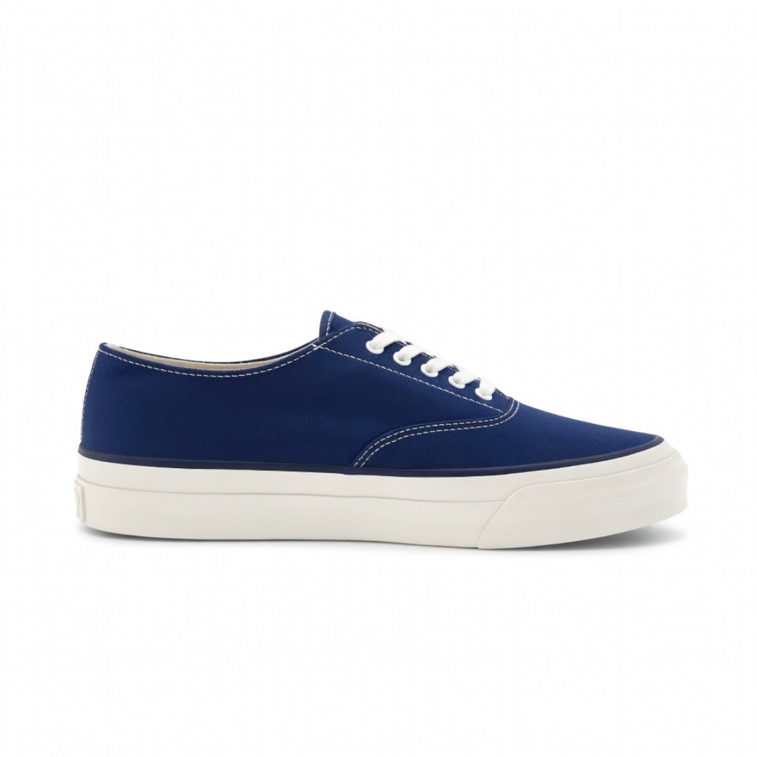 Asahi navy deck shoes displayed on a white background, showcasing classic slip-on design and comfortable leather material.
