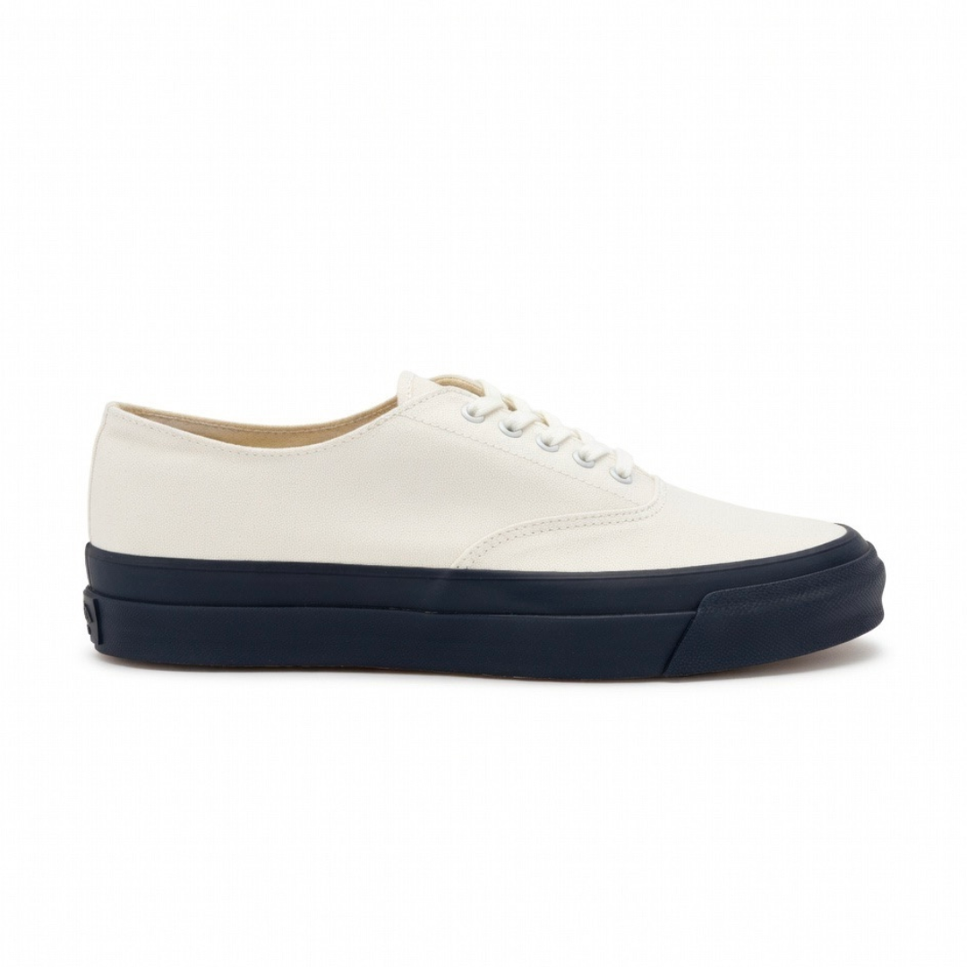 Asahi white and black deck shoes showing a casual slip-on style with white laces and a rubber sole.