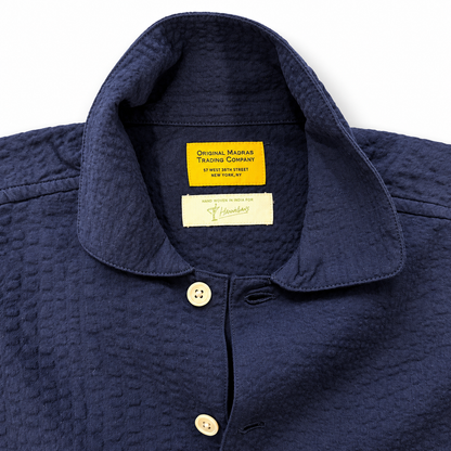 Original Madras Trading Co navy seersucker over shirt showing lightweight, textured cotton fabric and casual fit.