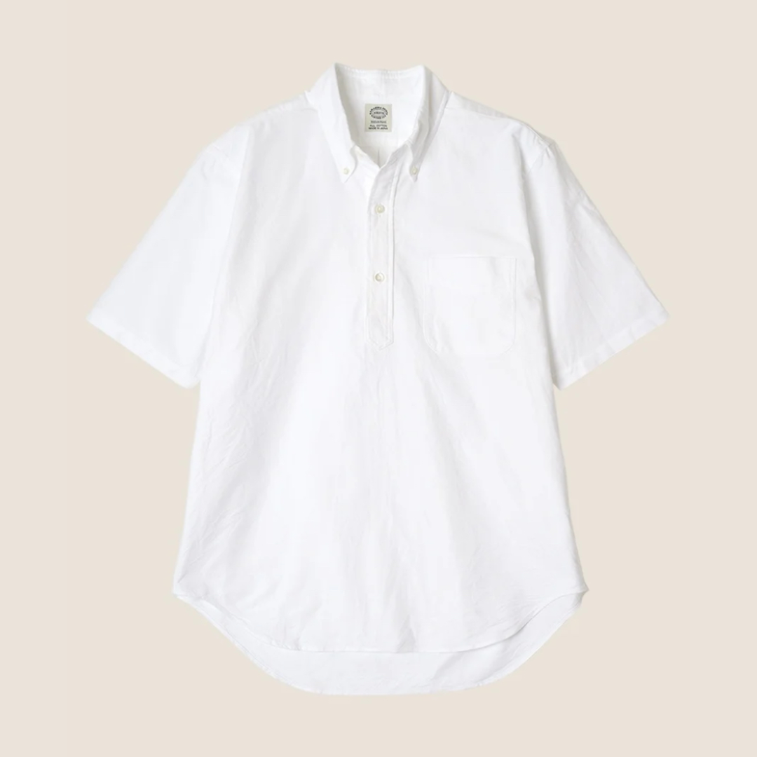 White button-up shirt on a beige background