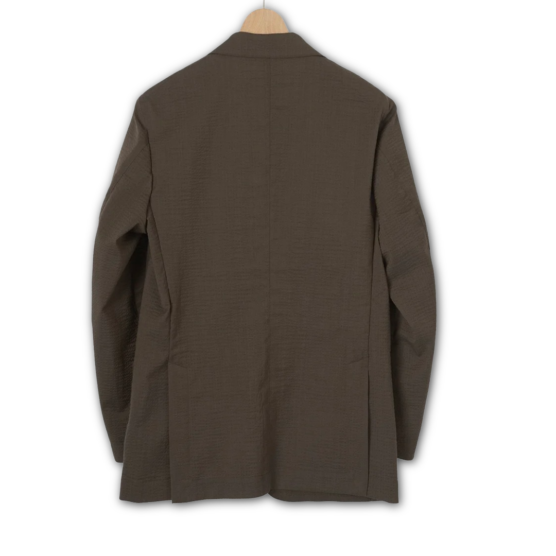 Kamakura brown seersucker jacket displayed on a hanger, showcasing lightweight, textured fabric and tailored fit.