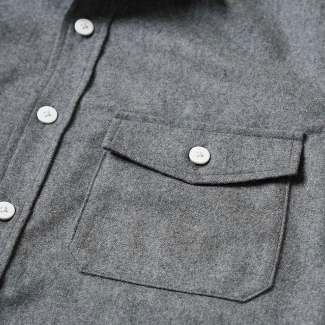 Kamakura grey wool flannel CPO over shirt displayed on a hanger, showcasing its soft fabric and classic button-up design.