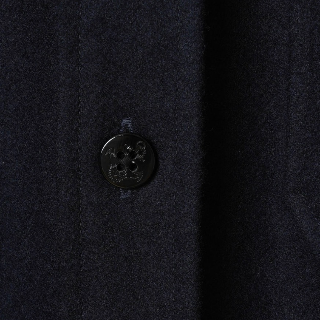Kamakura navy wool flannel CPO over shirt displayed on a hanger, showcasing its soft fabric and classic design.