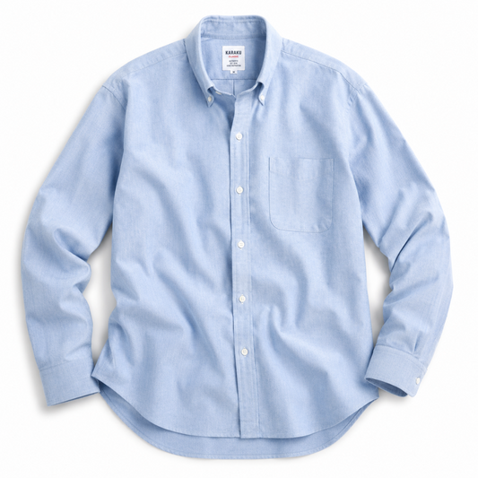 A light blue long-sleeve button-down shirt with a single chest pocket, laid flat on a white background. The brand name 'KARRABEE' is visible on the inner neck label.