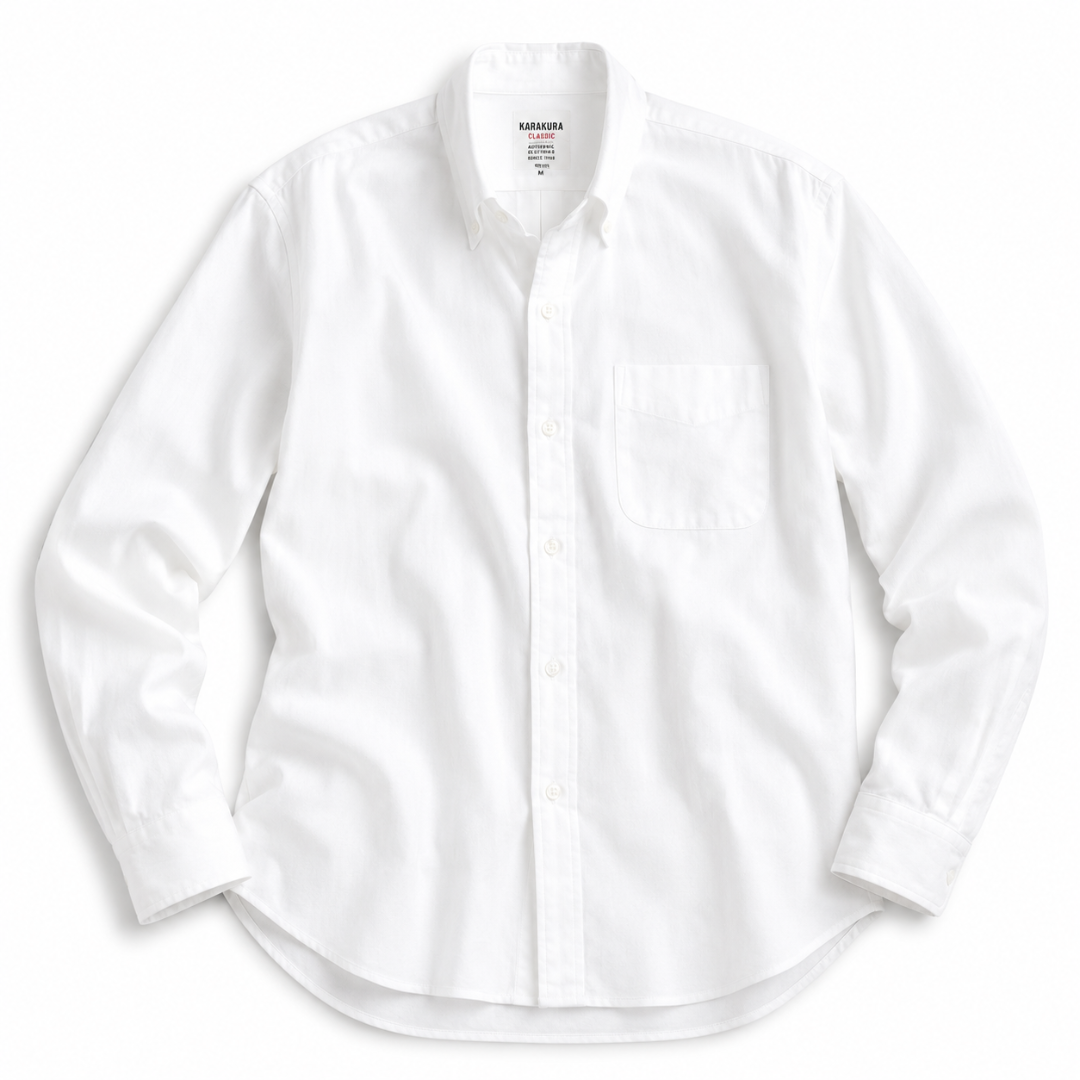 A white long-sleeve button-down shirt with a single chest pocket, laid flat against a white background.