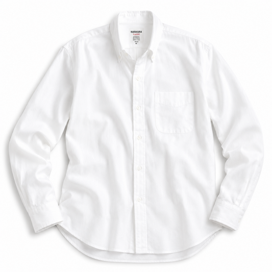 A white long-sleeve button-down shirt with a single chest pocket, laid flat against a white background.