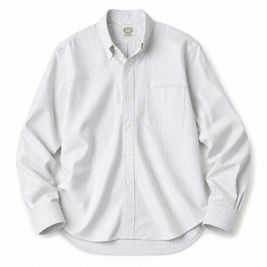 A white long-sleeve button-down shirt with thin vertical blue pinstripes, featuring a classic collar, button-up front, and a single chest pocket, laid flat against a white background.