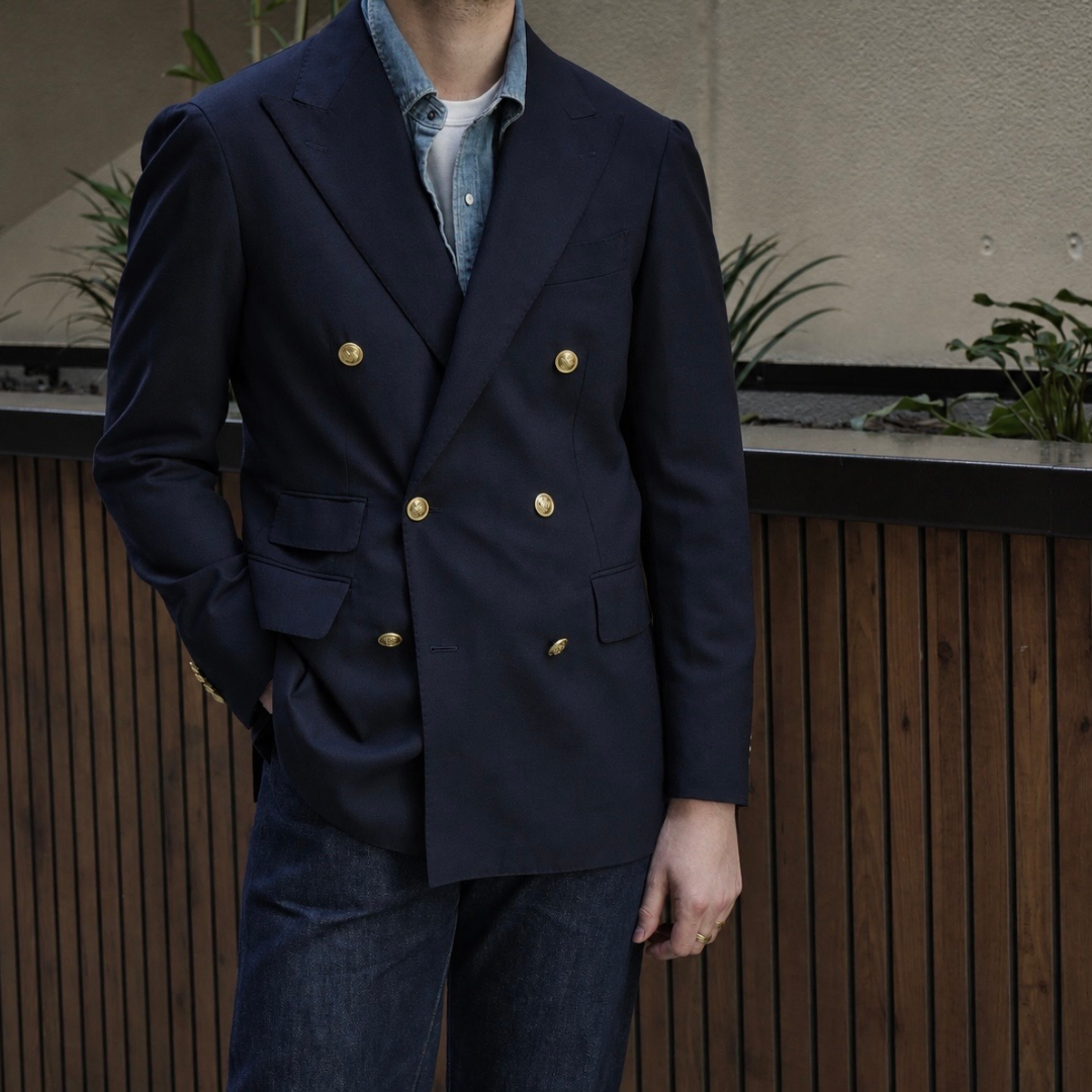 Ring Jacket navy double-breasted blazer with peak lapels, tailored fit, and front buttons, displayed on a mannequin.