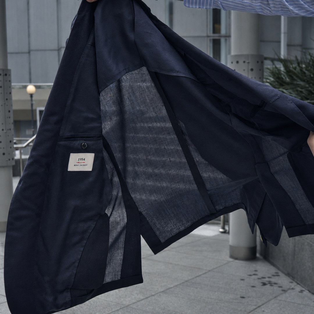 Ring Jacket navy double-breasted blazer with structured lapels and tailored fit, shown on a hanger.