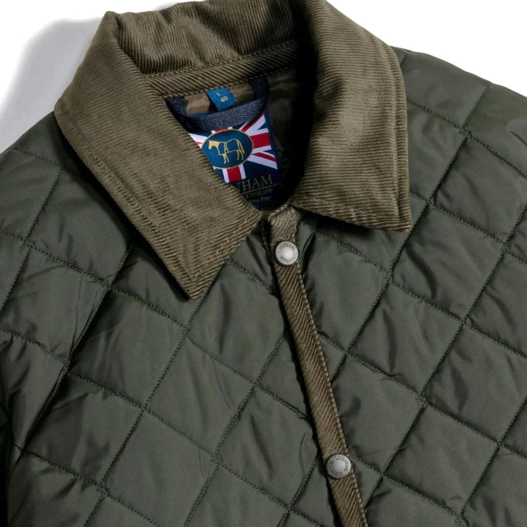 Green quilted jacket with a brand label on a white background