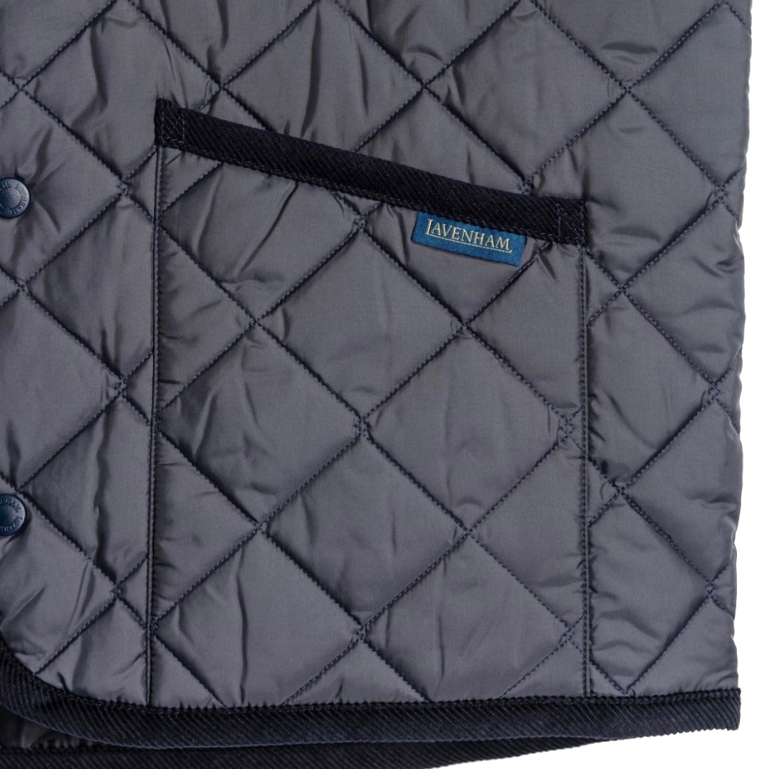 Lavenham Thornham Gilet in navy, a stylish men's outerwear vest with quilted design and front pockets, displayed on a hanger.