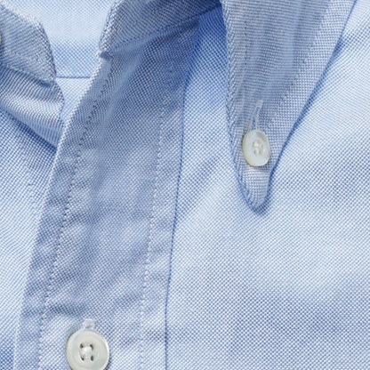 Kamakura Vintage IVY Blue Button Down Oxford shirt displayed on a hanger, showcasing its classic collar and button details.