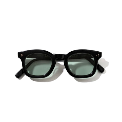 Black frame Guepard GP-17 sunglasses with dark green lenses, showcasing the stylish accessory with sleek design.