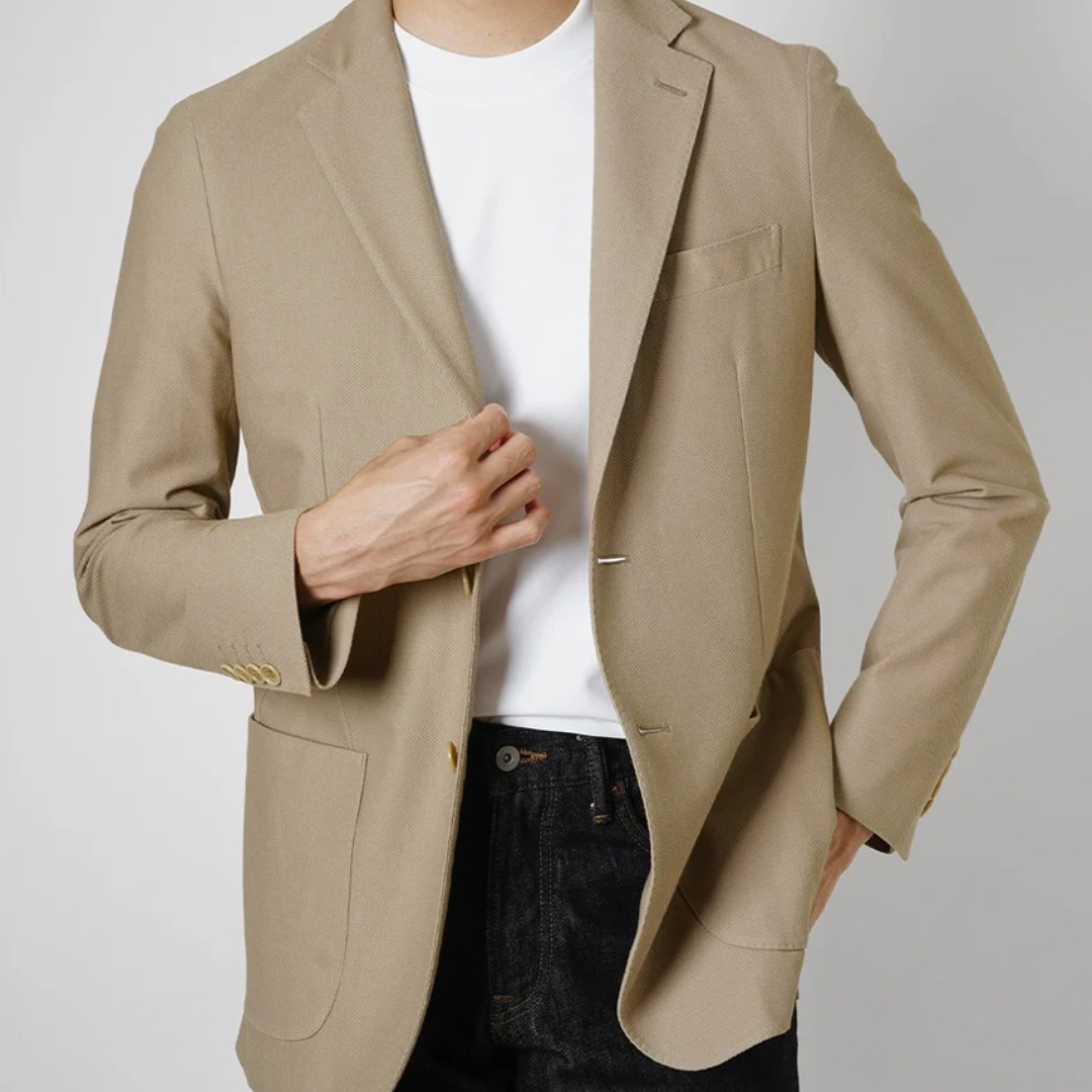 Kamakura beige cotton stretch blazer jacket with tailored fit and classic lapel, displayed on a hanger against a neutral background.