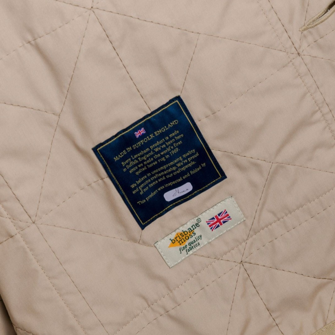 Lavenham unwadded worker jacket in stone color, showing the durable outerwear with a classic design and front pockets.